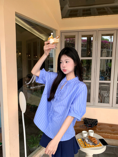 Actual shot of Korean chic Xia wearing a simple blue striped shirt and doll sweater