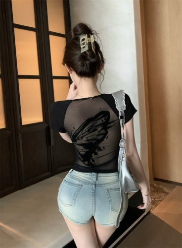 Real shot of hot girl with folded wings and butterfly in sexy mesh see-through back black short-sleeved tight top
