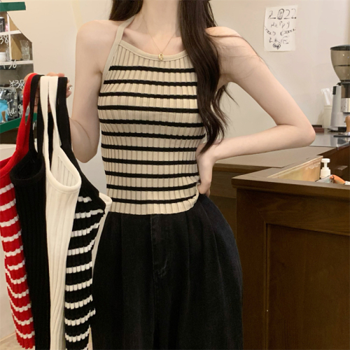 Real shot of a hot girl wearing a knitted camisole with a slim bottom and a beautiful back, wearing a sexy backless top
