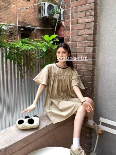 Real shot of energetic girl’s playful age-reducing little contrasting color doll dress