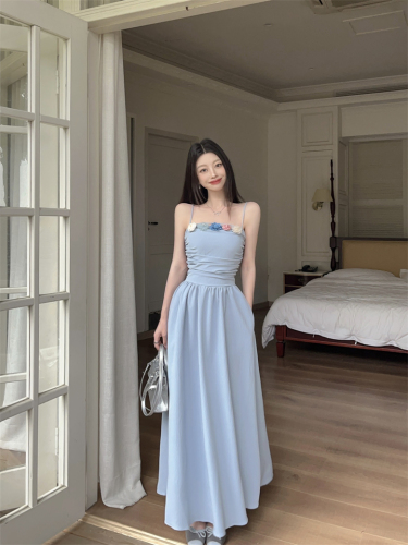 Real shot of beautiful pure lust flower suspender dress for women on seaside vacation, slim waist and French style long skirt