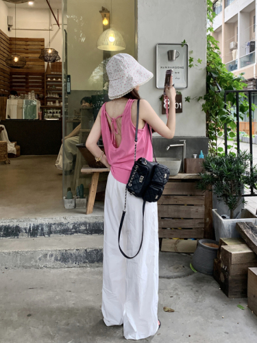 Actual shot of sleeveless top with straps on the back for women to wear outside + elastic waist and casual white wide-leg pants