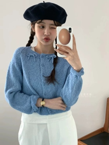 Now egg Korea Dongdaemun purchasing agent 2024 spring new fashion round neck oblique button bow knitted cardigan for women