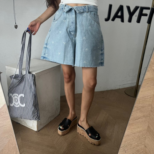 Raw edge quarter denim shorts with tiny bows on the back pockets