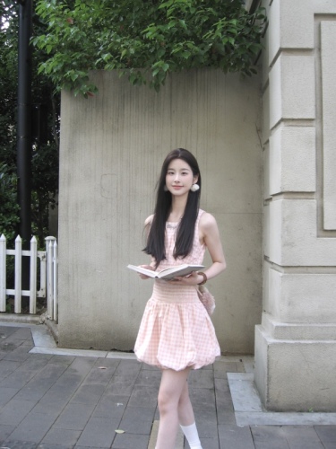 Real shot of a short dress with a sweet design and a waist-cinching plaid skirt.