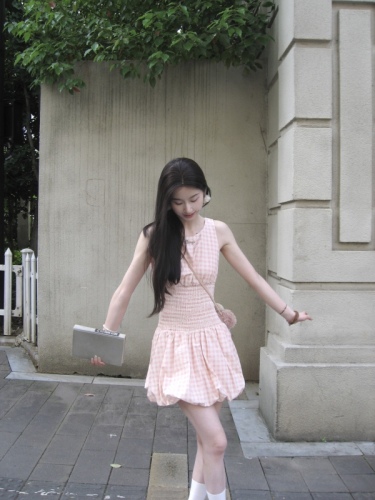 Real shot of a short dress with a sweet design and a waist-cinching plaid skirt.