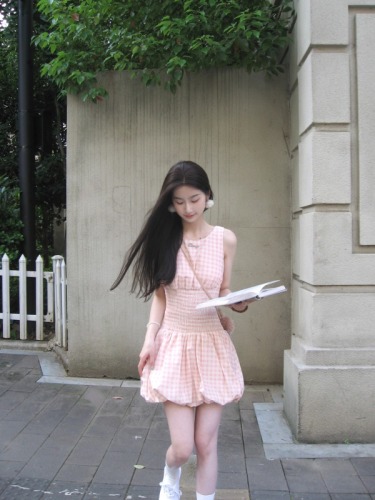 Real shot of a short dress with a sweet design and a waist-cinching plaid skirt.