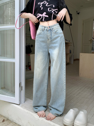 Actual shot of retro light-colored wide-leg denim floor-length trousers