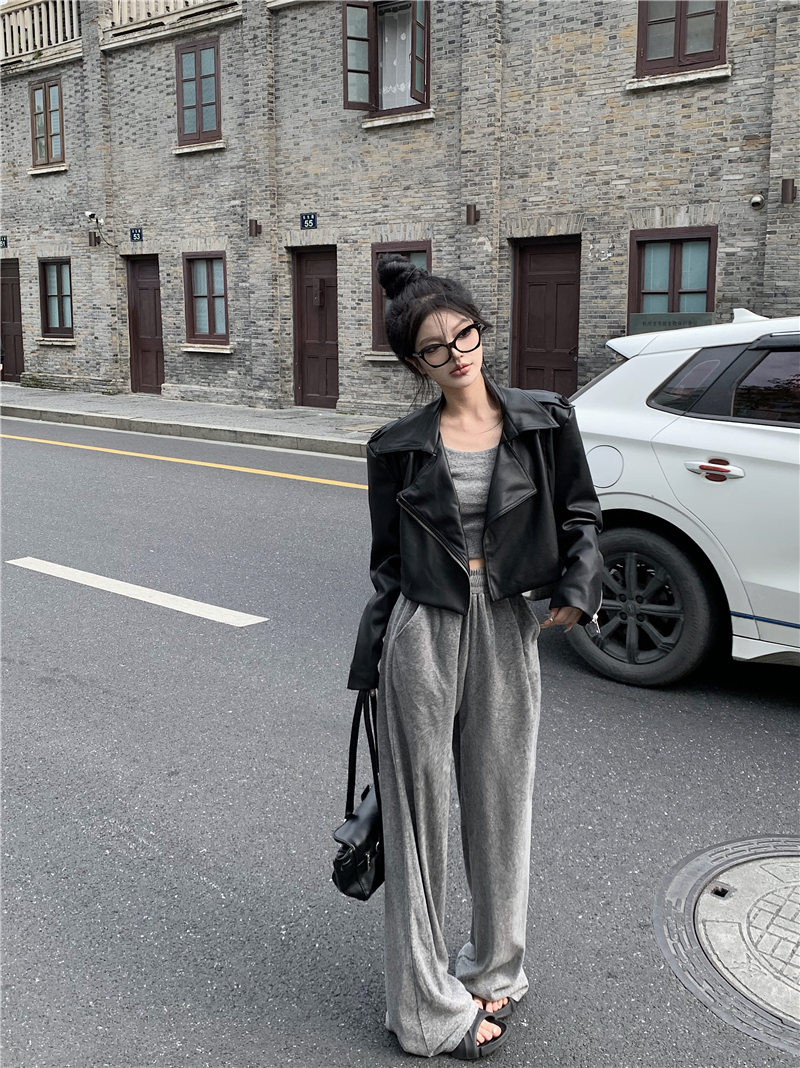 Actual shot of a two-piece set with a slim vest, elastic waisted straight trousers, and a short motorcycle leather jacket.