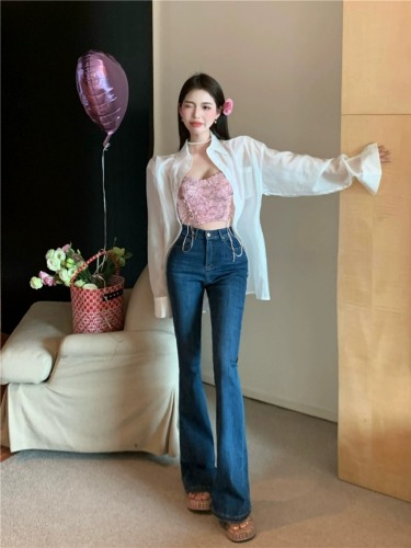 Actual shot of women's slim, high-waisted, stretchy, slightly-flared jeans and trousers worn with thin shirts