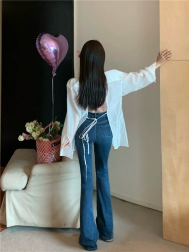 Actual shot of women's slim, high-waisted, stretchy, slightly-flared jeans and trousers worn with thin shirts