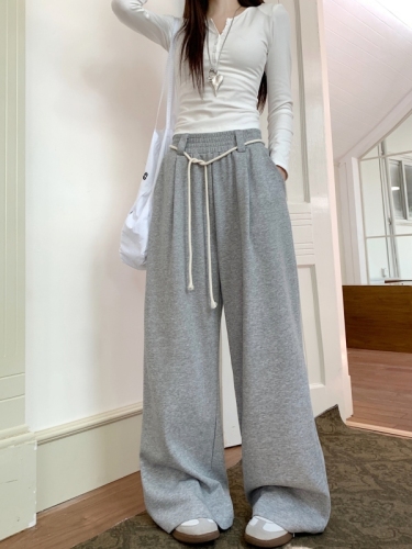 Actual shot of lazy style casual high-waisted straight wide-leg trousers with drapey floor-length trousers for women