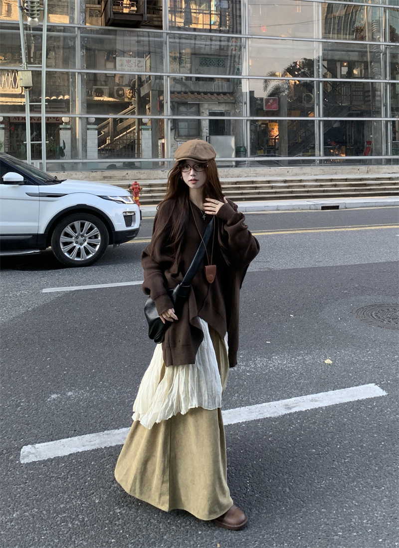 Layered set featuring a vintage and versatile loose-fit, asymmetrical knit sweater worn over a pleated shirt, paired with wide-leg casual pants for a relaxed and stylish look.