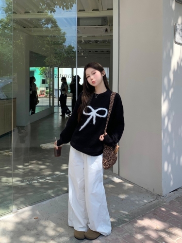 Real shot of black pullover sweater with bow for women in autumn and winter, lazy design knitted top
