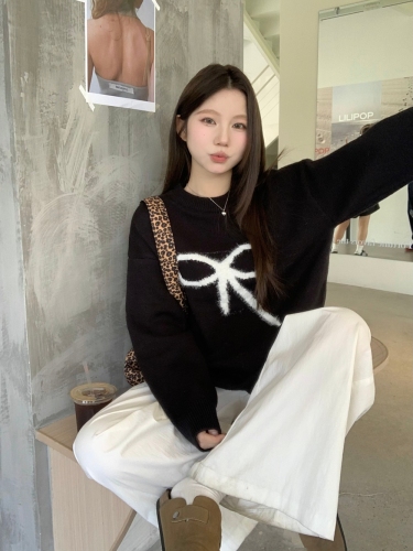 Real shot of black pullover sweater with bow for women in autumn and winter, lazy design knitted top