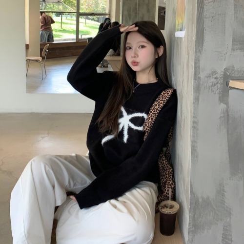 Real shot of black pullover sweater with bow for women in autumn and winter, lazy design knitted top