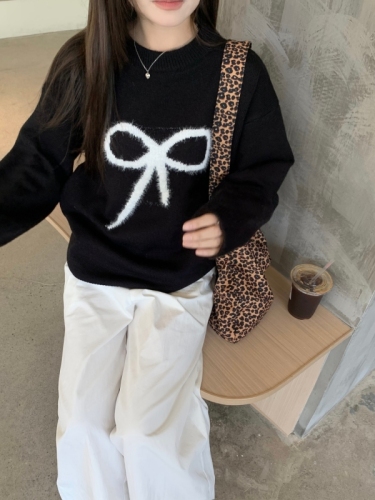 Real shot of black pullover sweater with bow for women in autumn and winter, lazy design knitted top