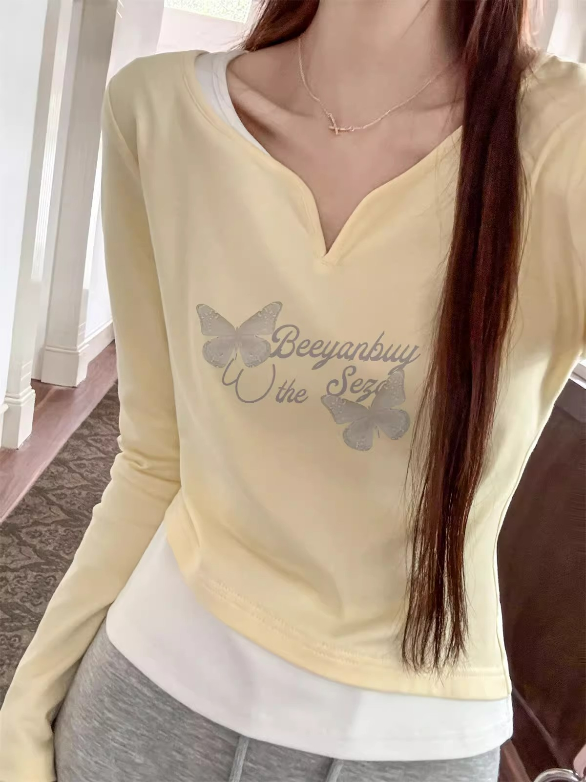 Korean yellow long-sleeved T-shirt for women 2024 spring and autumn new niche gentle slimming fake two-piece short top