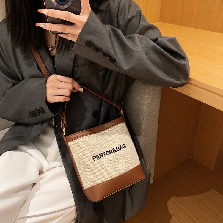 High-end portable bucket bag for women, new fashionable letter canvas bag, texture niche single shoulder crossbody bag