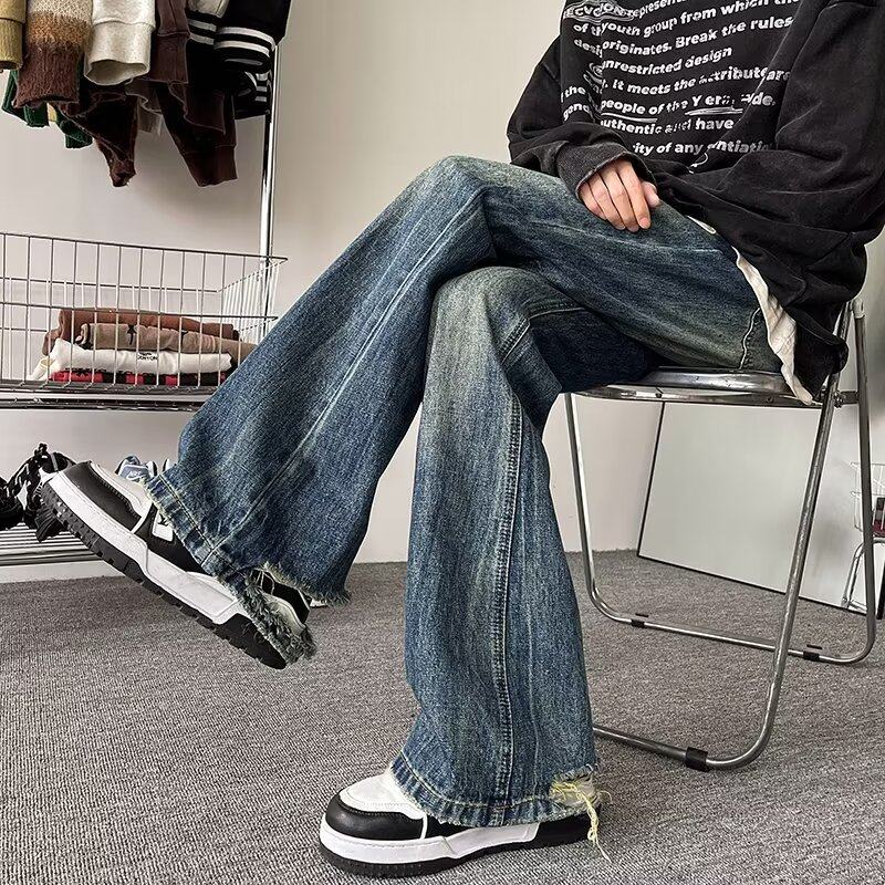 Tie-dyed distressed trousers with holes in the hems and micro-flared pants vibe high street retro straight jeans