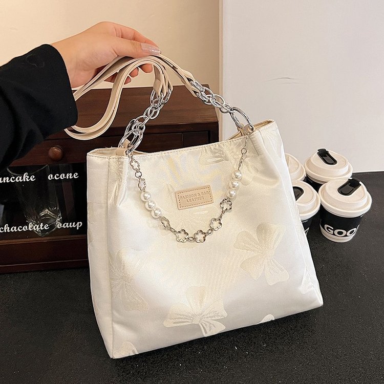 Niche design large capacity portable canvas bag for women summer 2024 new fashion printed bow shoulder tote bag