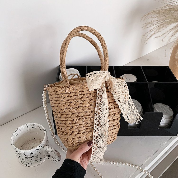 Spring and summer new straw woven bags, portable bucket bags, shoulder crossbody bags, beach vacation women's bags, pearl chains