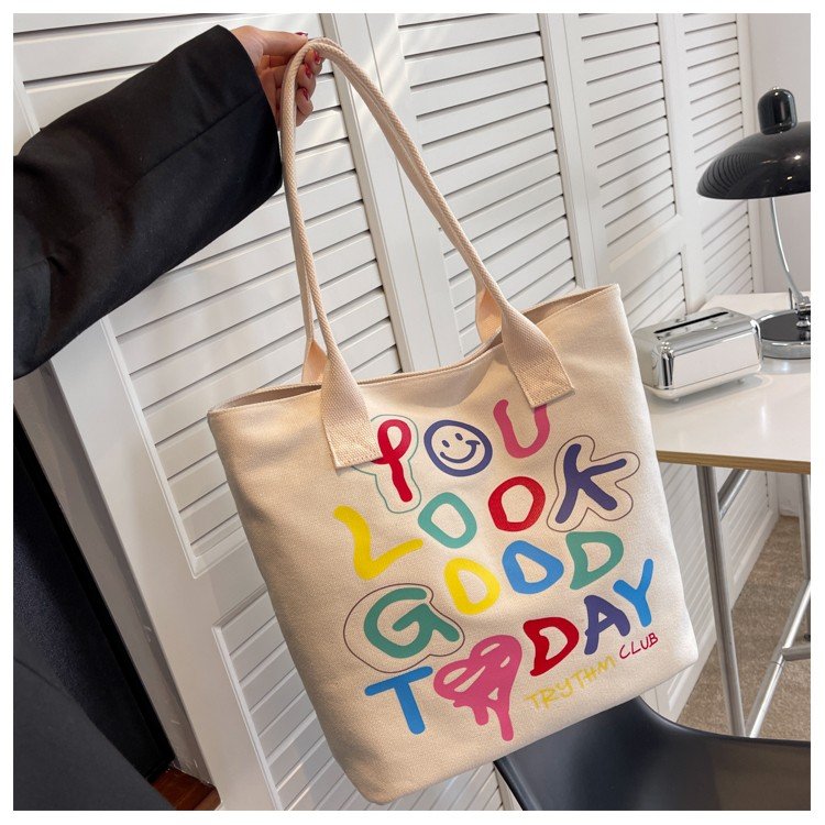 One-shoulder portable canvas bag for women spring and summer new style literary style simple printing large capacity student hand carry