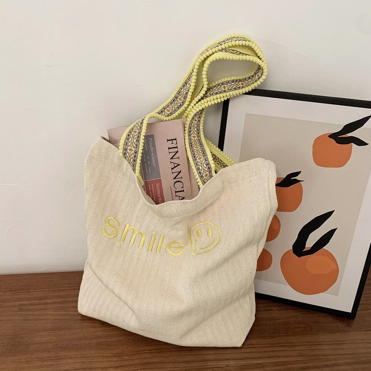 Korean ins embroidered smiley face large capacity shoulder bag fur ball shoulder strap student class female canvas bag wholesale