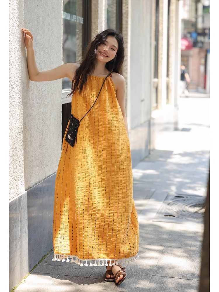 Yellow tassel suspender dress for women in summer, super high-end and beautiful seaside vacation long skirt