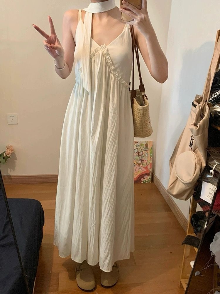 Seaside vacation style sleeveless suspender dress for women in summer milky apricot color backless A-line skirt loose slim long skirt