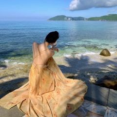 度假風海邊氛圍感落日黃昏黃色純欲露背吊帶掛脖露背大擺超仙長裙