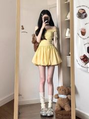 鵝黃色蝴蝶結系帶吊帶連衣裙女夏初戀甜美設計感a字花苞蓬蓬短裙