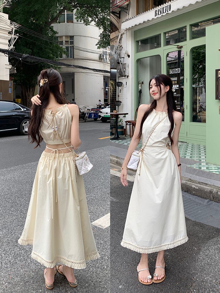 Seaside niche design sense hollow waist-exposed halter neck suspender dress for women in summer waist-hugging and slimming tassel long skirt