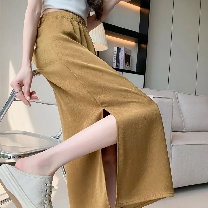 A mid-length acid-embossed gold-plated split skirt for women, suitable for summer, unique, muscle-hiding, textured, high-waisted, and flowing.
