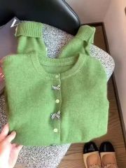 綠色圓領蝴蝶結針織開衫女春秋設計感軟糯慵懶百搭浣熊絨毛衣外套