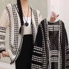 Retro black and white striped V-neck medium-length knit sweater with lace-up autumn and spring season, elegant minimalist design, trendy outerwear.