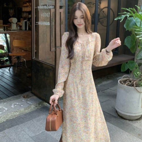 Real-shot, soft-style dress featuring a ruffled hem, tie-up details, and delicate floral patterns—designed with a cinched waist for a slimming, elegant look.