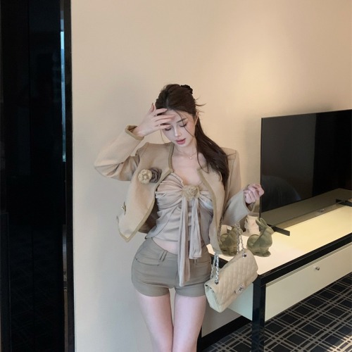 Real-life shot: Chanel-style suit with 3D floral details, pleated design, and a ribboned vest paired with a long-sleeve coat