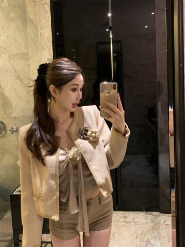 Real-life shot: Chanel-style suit with 3D floral details, pleated design, and a ribboned vest paired with a long-sleeve coat