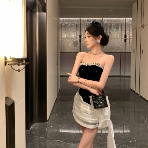 Real-shot, luxe yet understated waist-defined, contrasting-color, finely shimmering velvet tube dress—sheath-style with tie-up details for a sleek, figure-flattering fit.