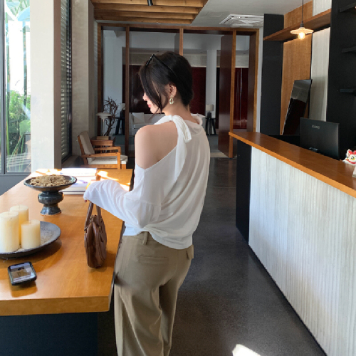 The photo-realistic image features a stunning white sleeveless off-shoulder top with a neck tie, creating a chic look. The crop top has long sleeves and accentuates the waist beautifully.