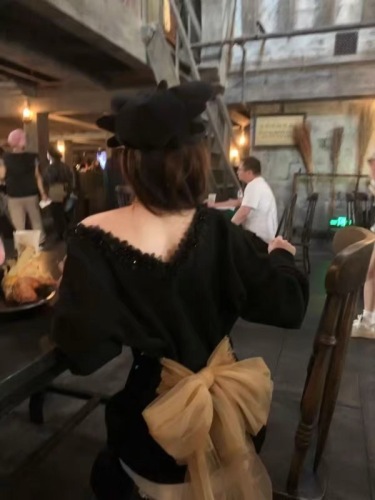 Korean-style black bow-knot backless long-sleeved sweater for women—autumn/winter thickened, laid-back style, spicy girl-style knitted off-shoulder top.