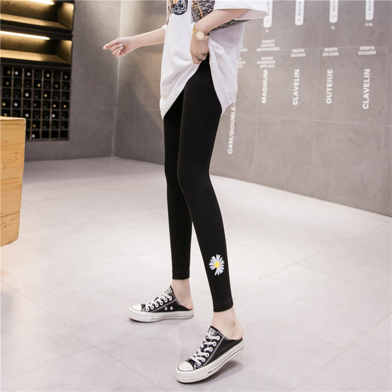Women's Leggings are tight, high waisted and thin. They wear small daisy embroidered sports elastic liquid pencil pants