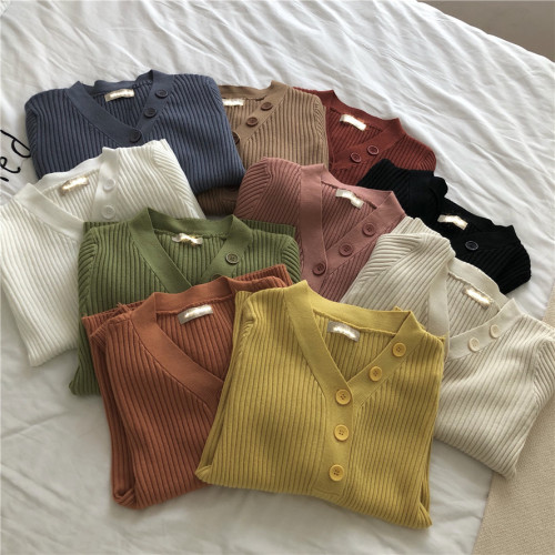 A row of button-down knitted sweaters with V collar
