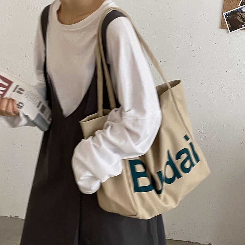 Student casual large-capacity bag women's autumn and winter 2021 new trendy fashion alphabet canvas bag Korean version shoulder cloth bag