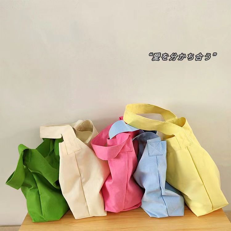 New 2022 spring and summer new butterscotch color canvas bag with a fashionable hand bag student school bag