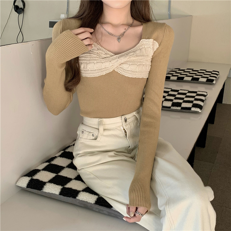 Actual shot of a new autumn style twist knitted sweater top with long sleeves and a sweater base layer