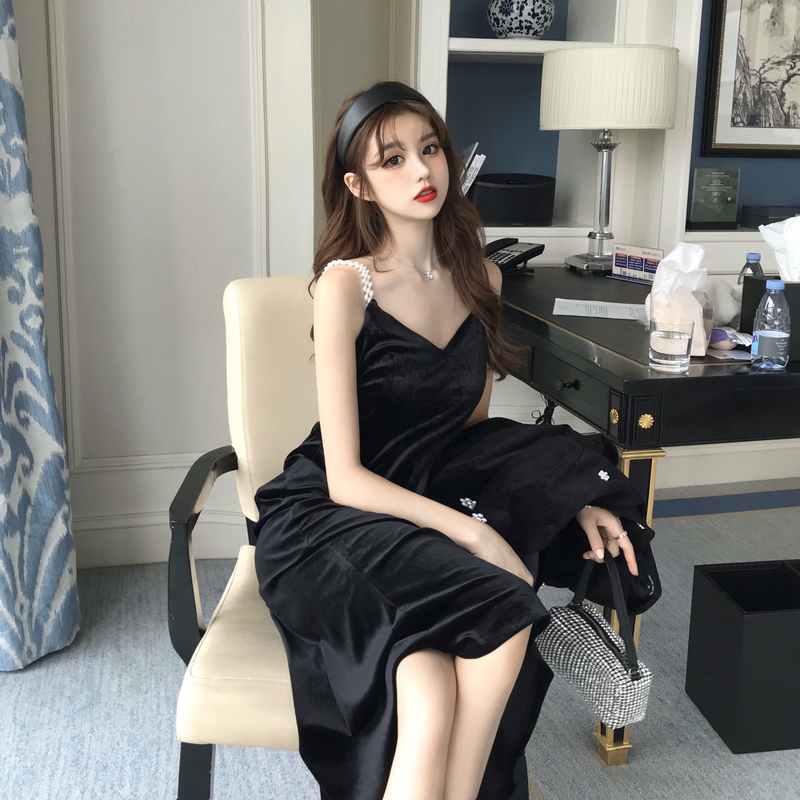 Actual shot of fashionable and sexy mid-length V-neck velvet and pearl strap bottoming dress