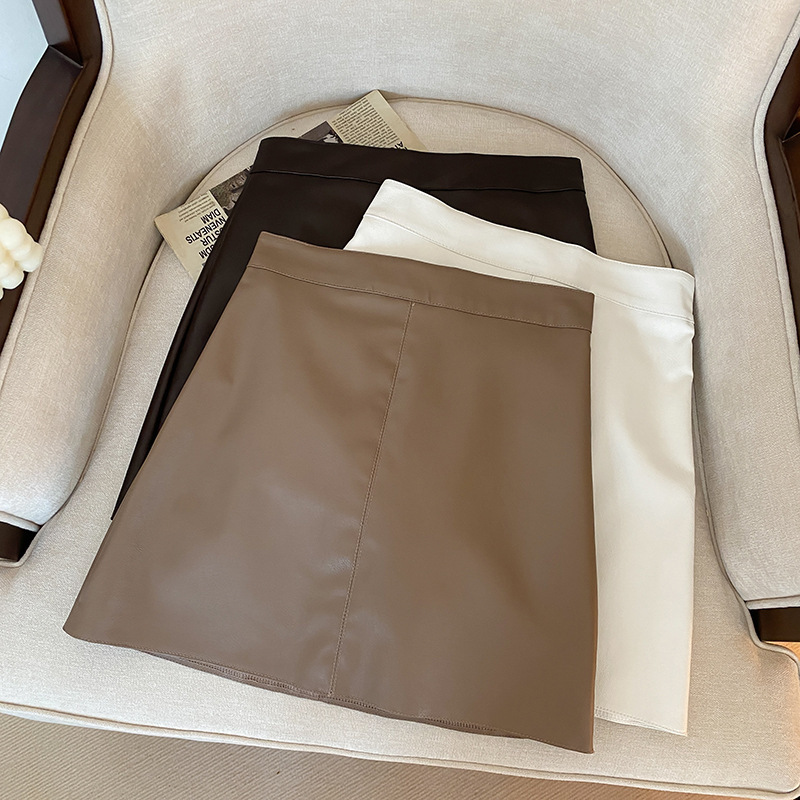 A-line skirt for women in autumn and winter with sweater for small people. This year's popular black high-waisted PU leather hip short skirt