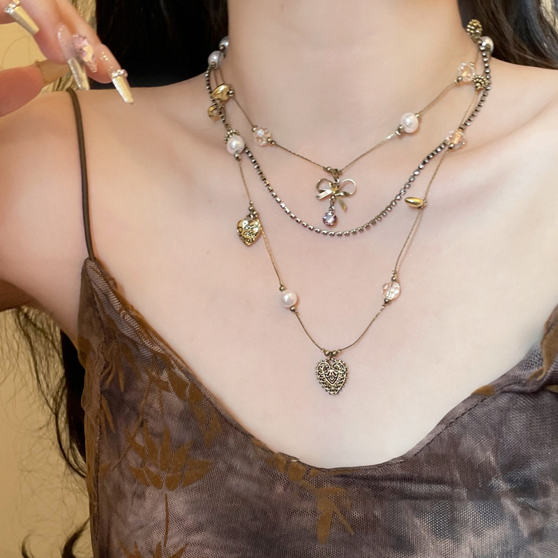 Medieval vintage bow pearl love multi-layer clavicle chain for women 2024 popular retro light luxury necklace trend
